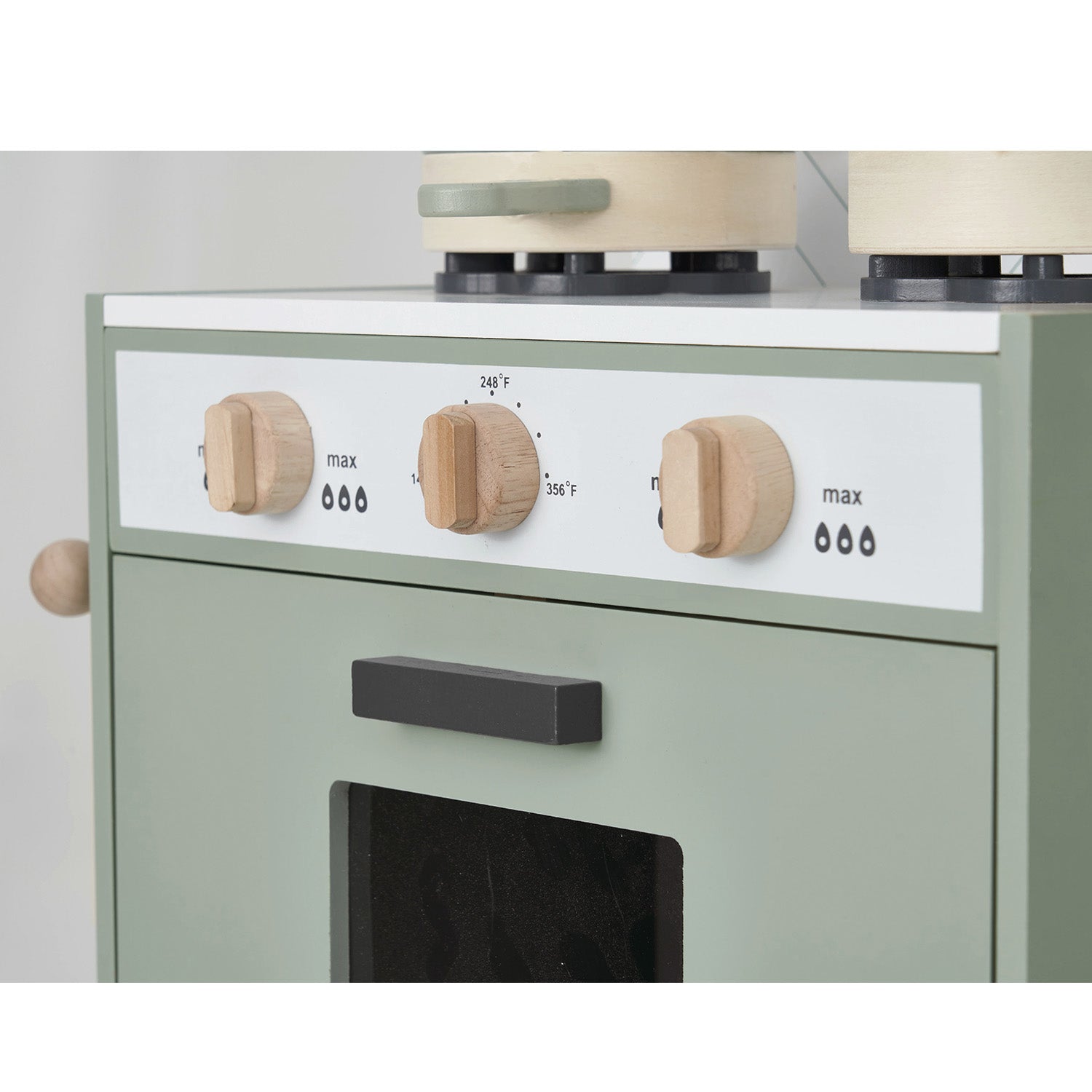 Green oven with wooden knobs on a white background